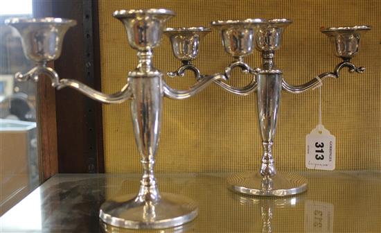Pair of 1950s silver two branch three light candelabra, weighted(-)